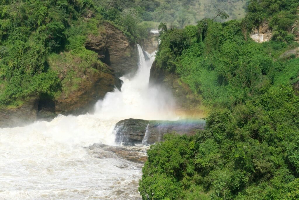 a waterfall with a rainbow in the middle of it