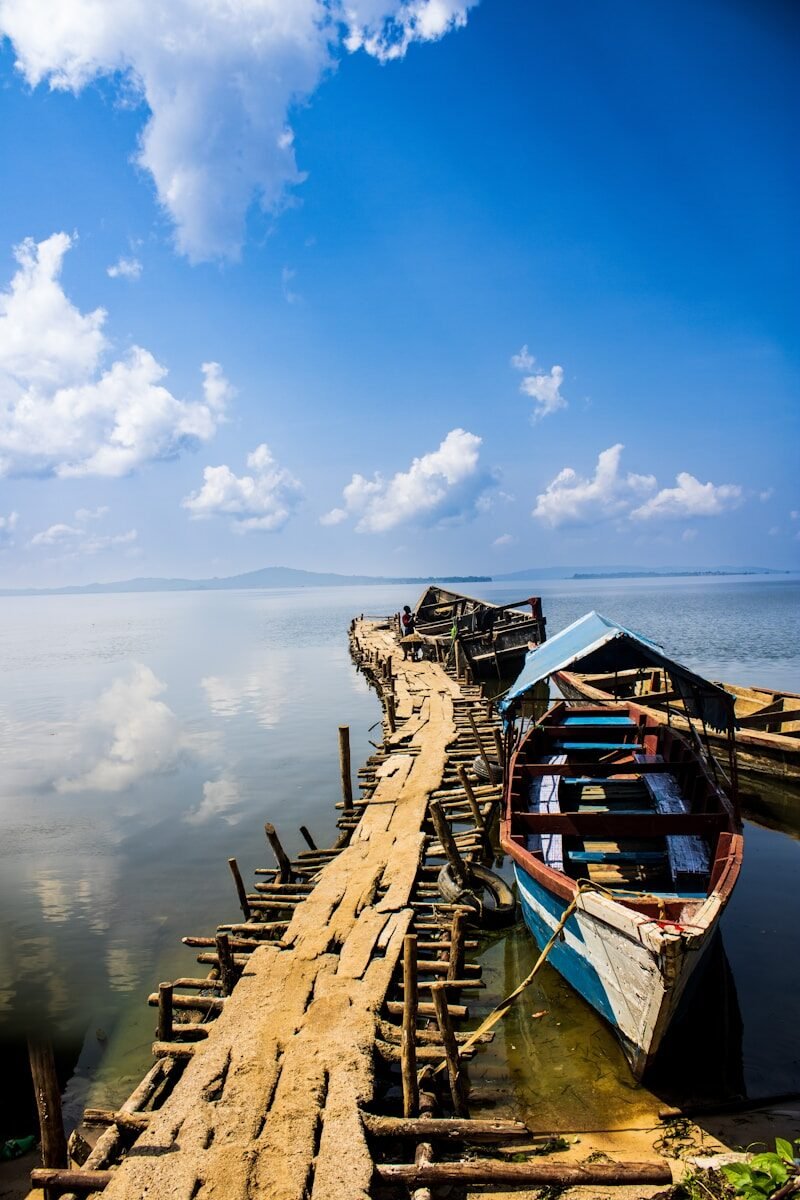 a long wooden dock with several boats on it